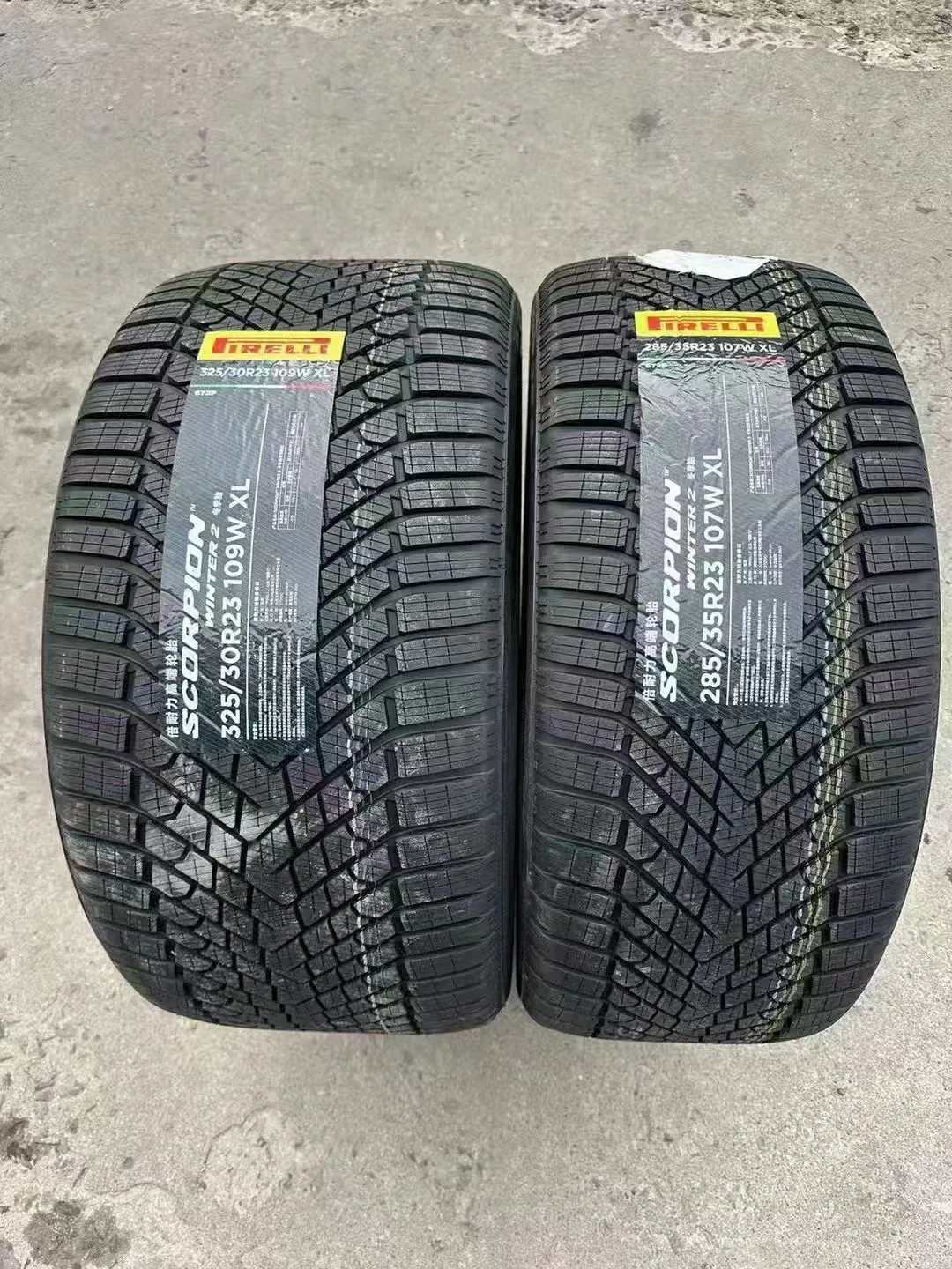 Pair of new winter tires showing two tread patterns